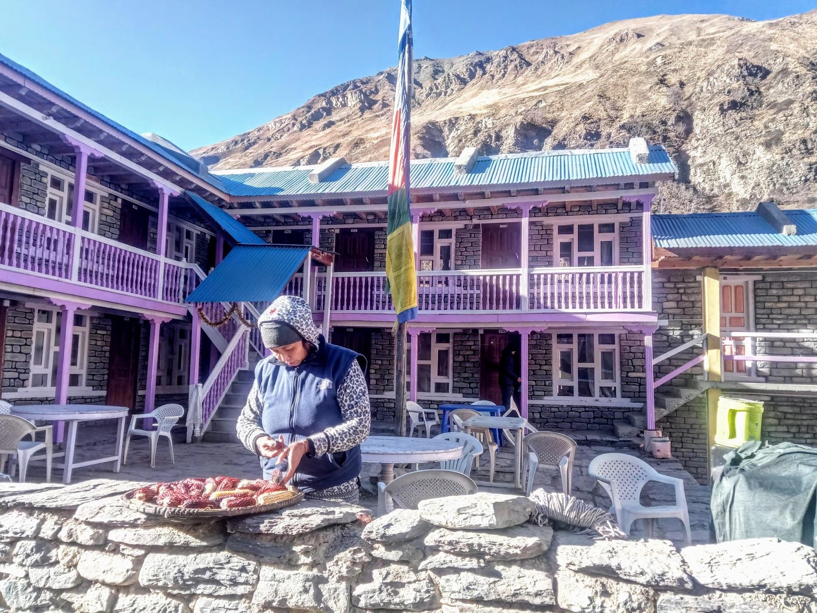 A women preparing to dry maize in the sun in one of the hotels in Manang region.