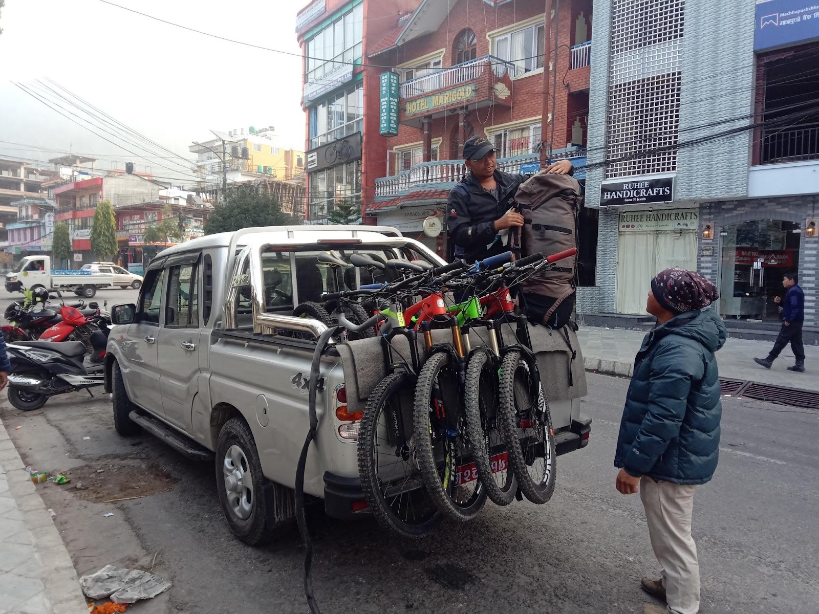 Two supporting staff loading the bikes and bag to start the trip to Annapurna Circuit mountain biking.