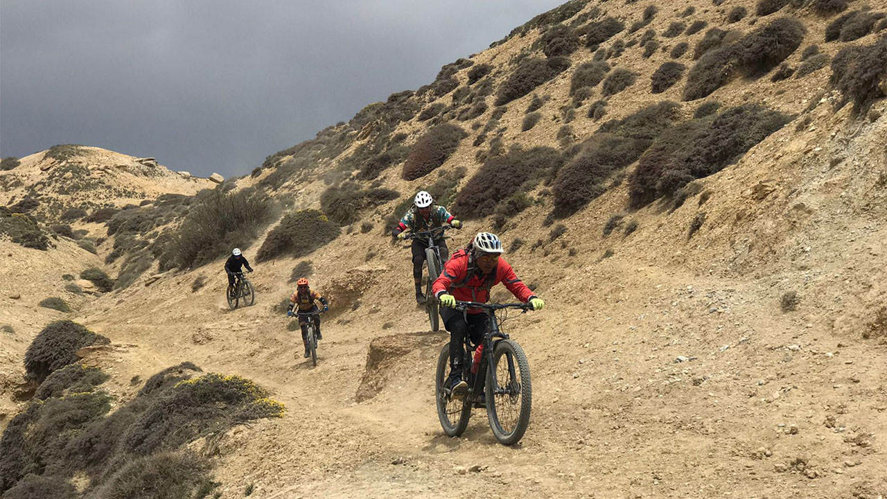 Four mountain bikers enjoying their ride through off the beaten trail of Mustang.