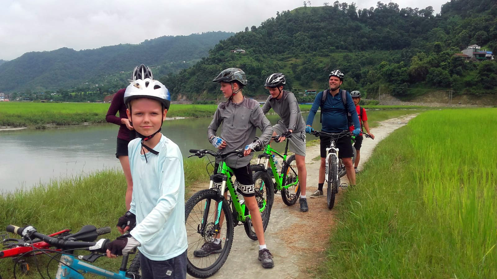 A group of family members are mountain biking along the Harpan River in Pame vilage, Pokhara.
