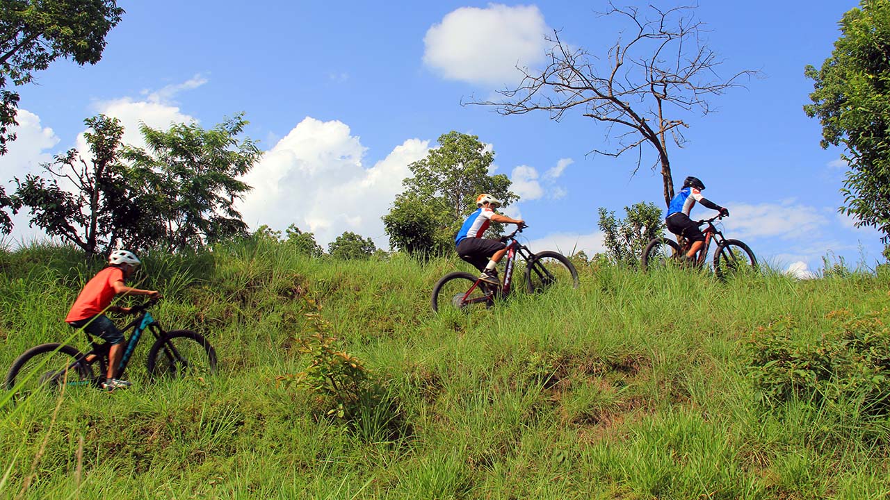 Mountain bikers easily tackling the difficult climb with the help of electric mountain bike.