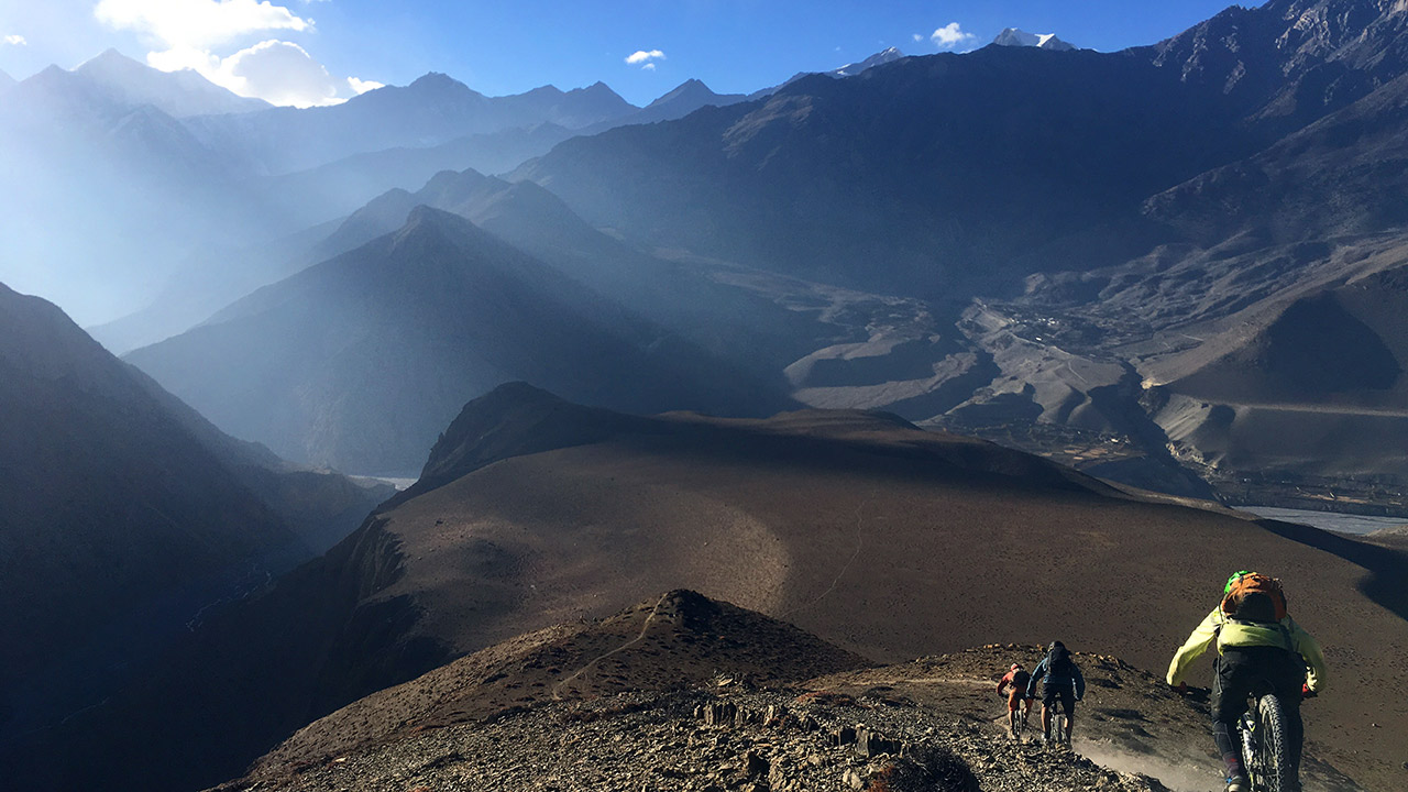 Three mountain bikers are rolling down the Lupra single track of Mustang.