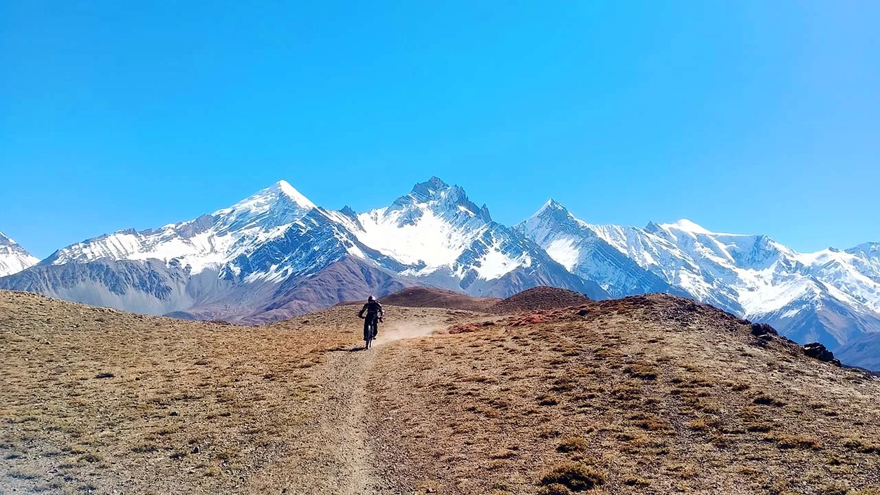 A mountain biker descends through the Lupra Single track in Mustang during the enduro MTB adventure in the Himalayas of Nepal.