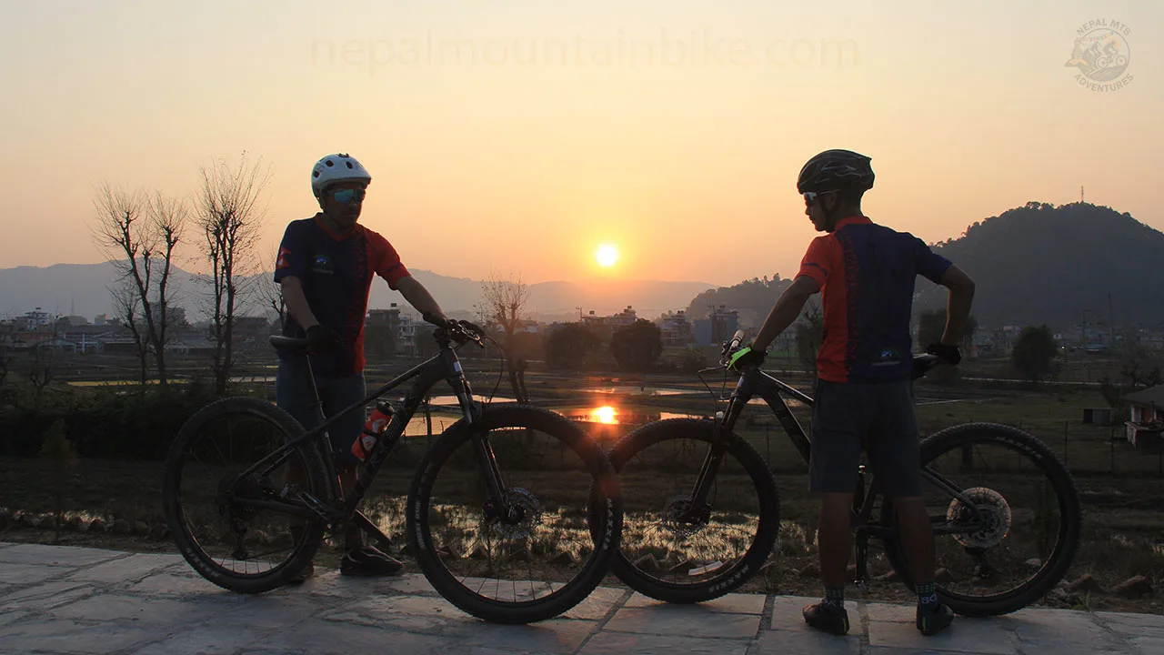 Mountain bikers enjoying the sunset during the guided day tour in the Begnas Lake of Pokhara.