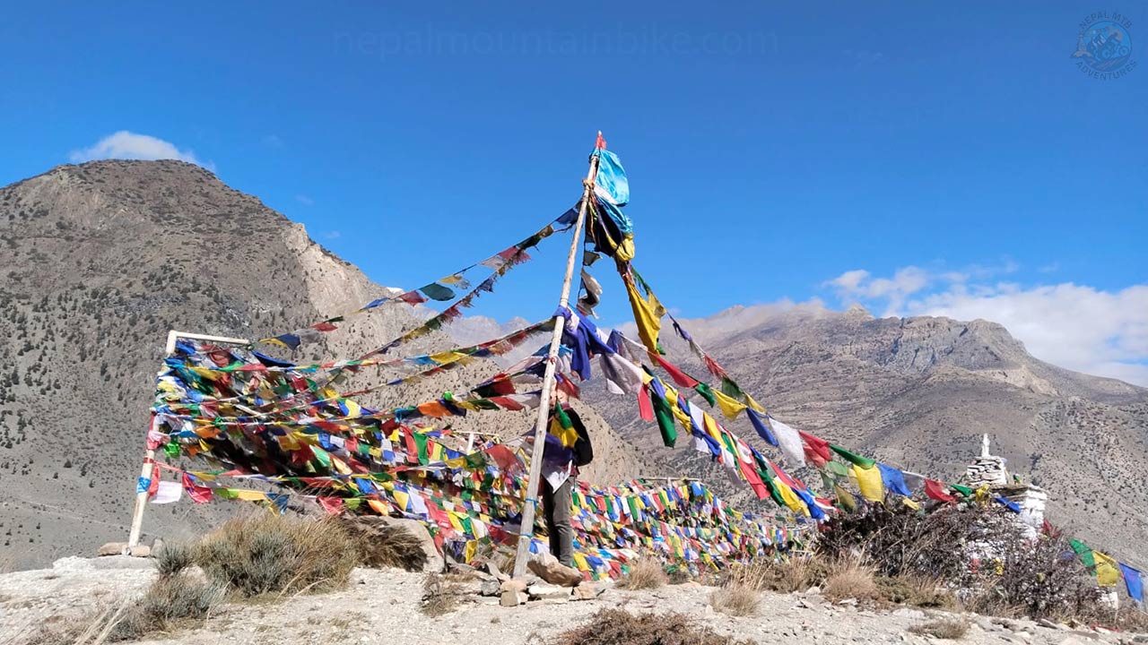 Tibetan prayer flags caught in camera during Upper Mustang Mountain bike tour package with Nepal MTB Adventures.