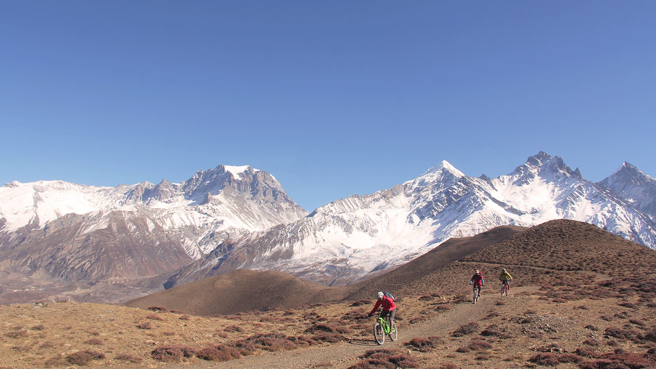 Enduro bikers in action in the Lupra Singletrack in Mustang, Nepal.