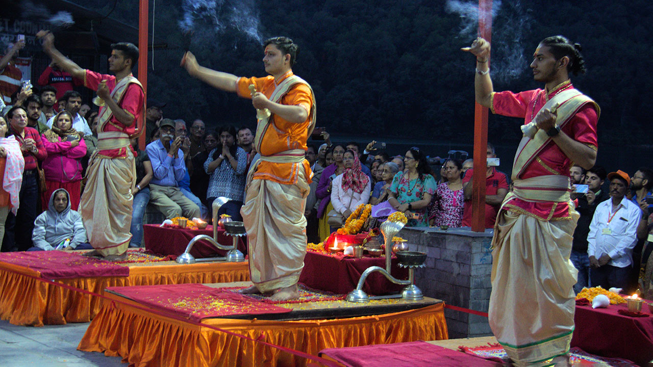 Priests are performing the Aarti ritual on the bank of Fewa Lake at Barahi Temple while the pilgrims are enjoying the ritual.