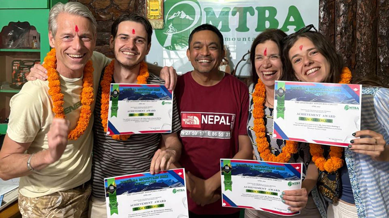 E-Mountain bikers receiving achievement award after the completion of Himalayan E-MTB guided Tour in Nepal.