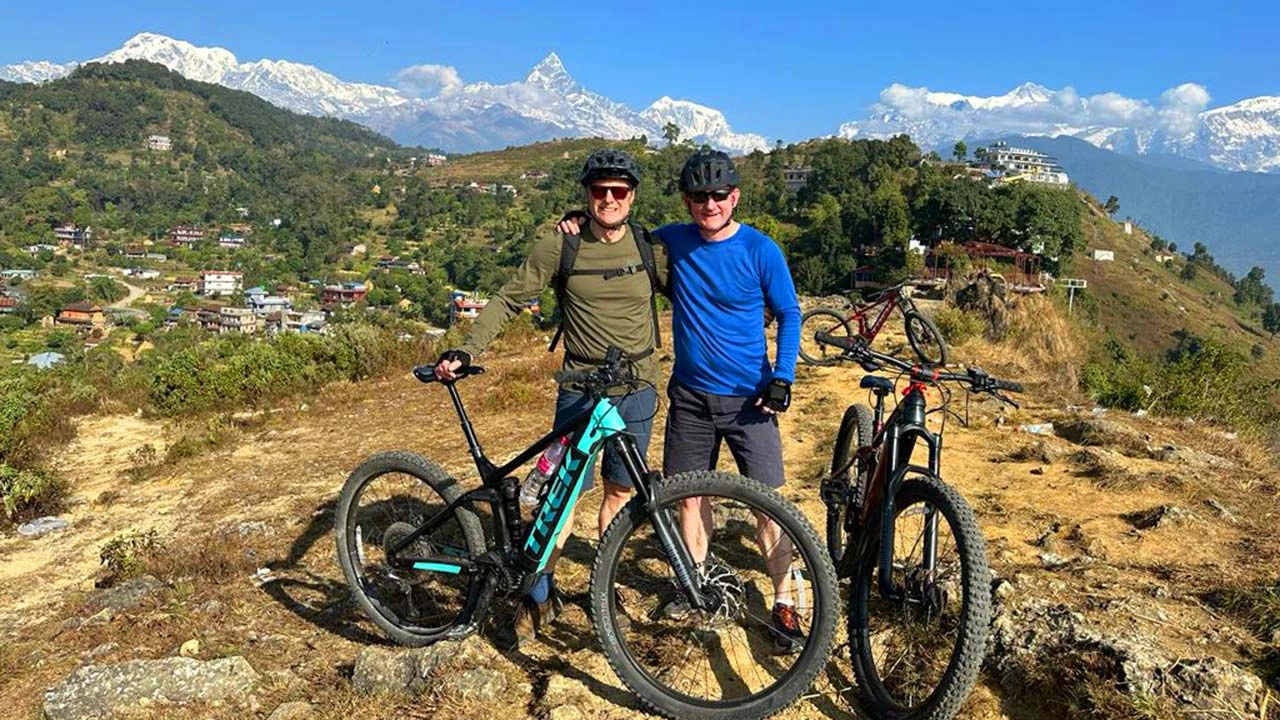 E-MTB riders are taking picture with the backdrop of Fishtail and Annapurna Mountain range during Nepal E-MTB cycling tour.