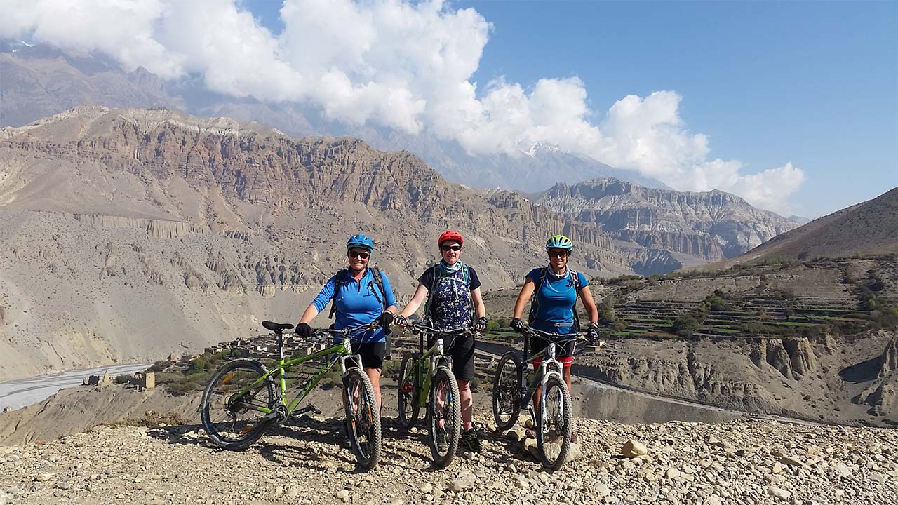 Three women are ready to capture to capture their wonderful moment of mountain biking in Mustang.