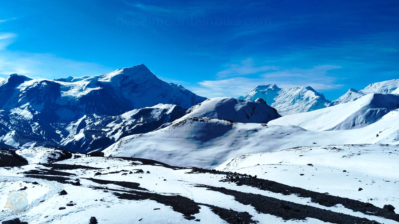 Views of the Himalayas while ascending the Thorong-La Pass during the Annapurna Circuit mountain bike tour with Nepal MTB Adventures.