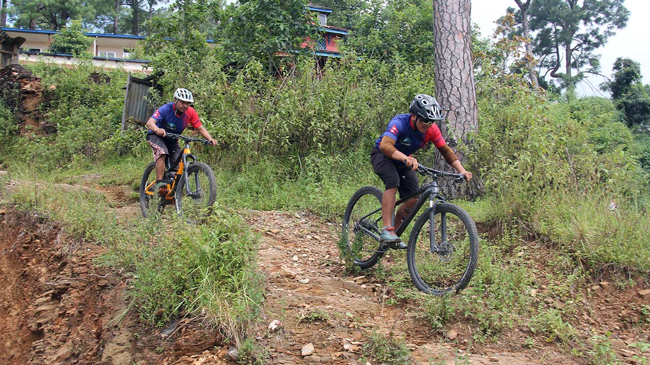 Mountain bikers are rolling down the techy single trail through the pine forest of Dhading.