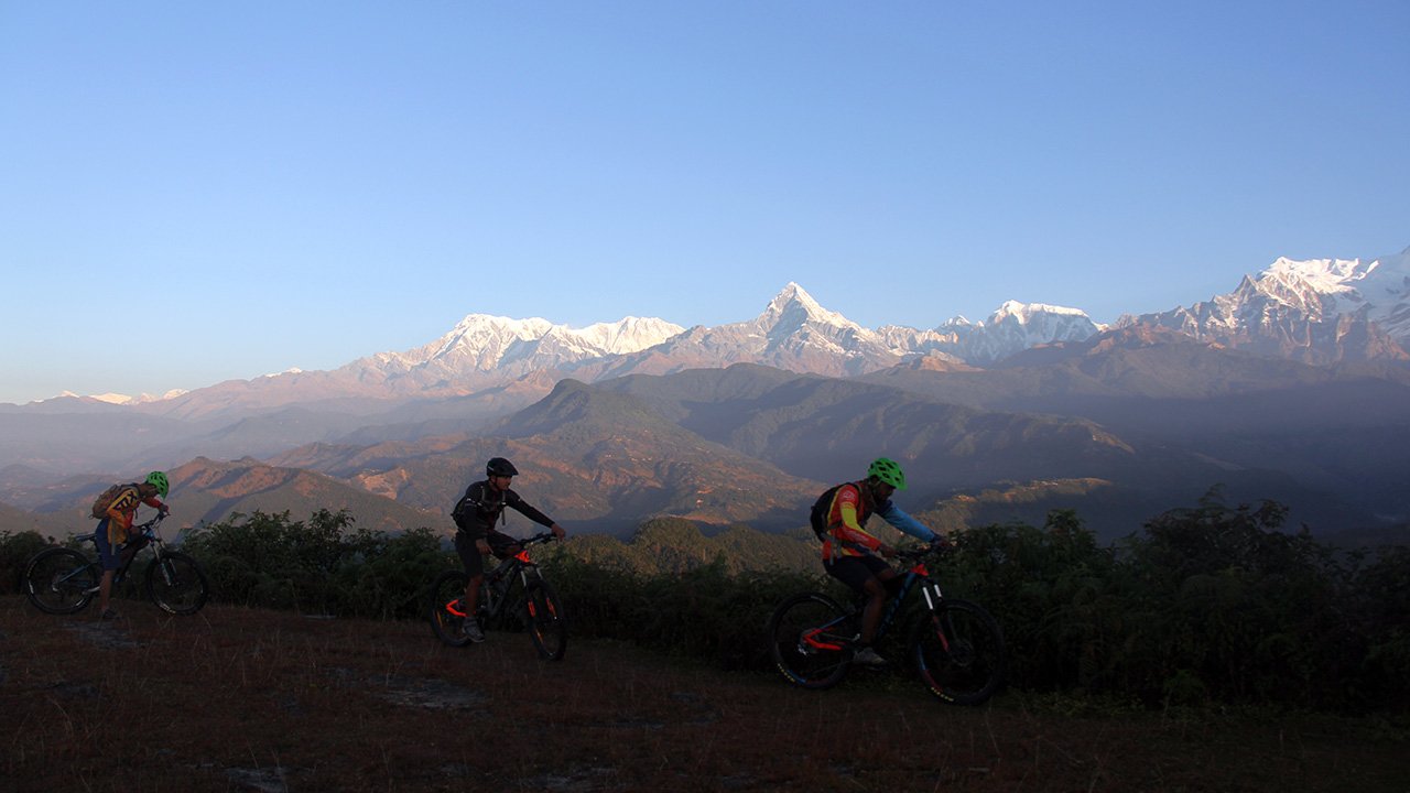 Mountain bikers are starting their ride with the view of Annapurna and Fishtail to Begnas Lake.