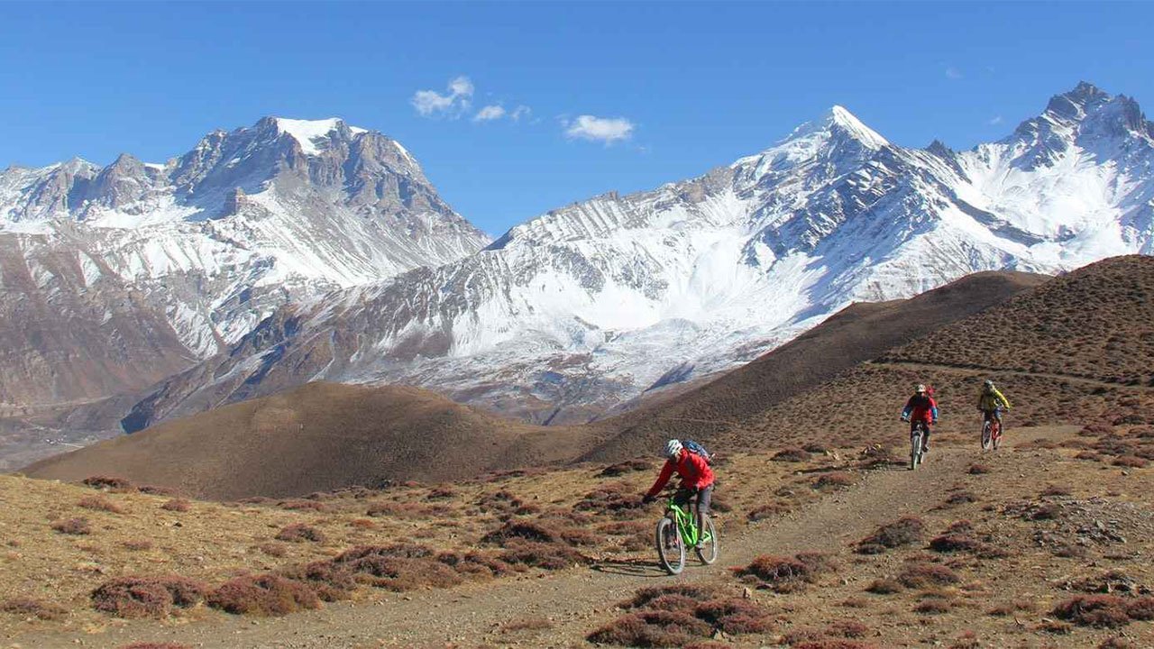 Three mountain bikers are rolling down the Lupra single track in Lower Mustang.