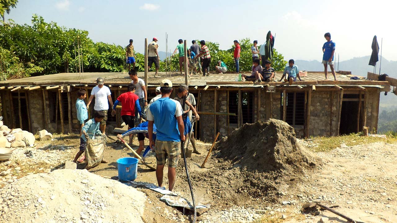 Group of people are offering volunteer service to construct a school in Syangja. 